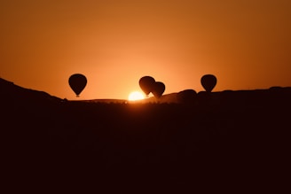 A group of hot air balloons flying in the sky