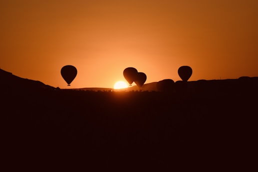 A group of hot air balloons flying in the sky