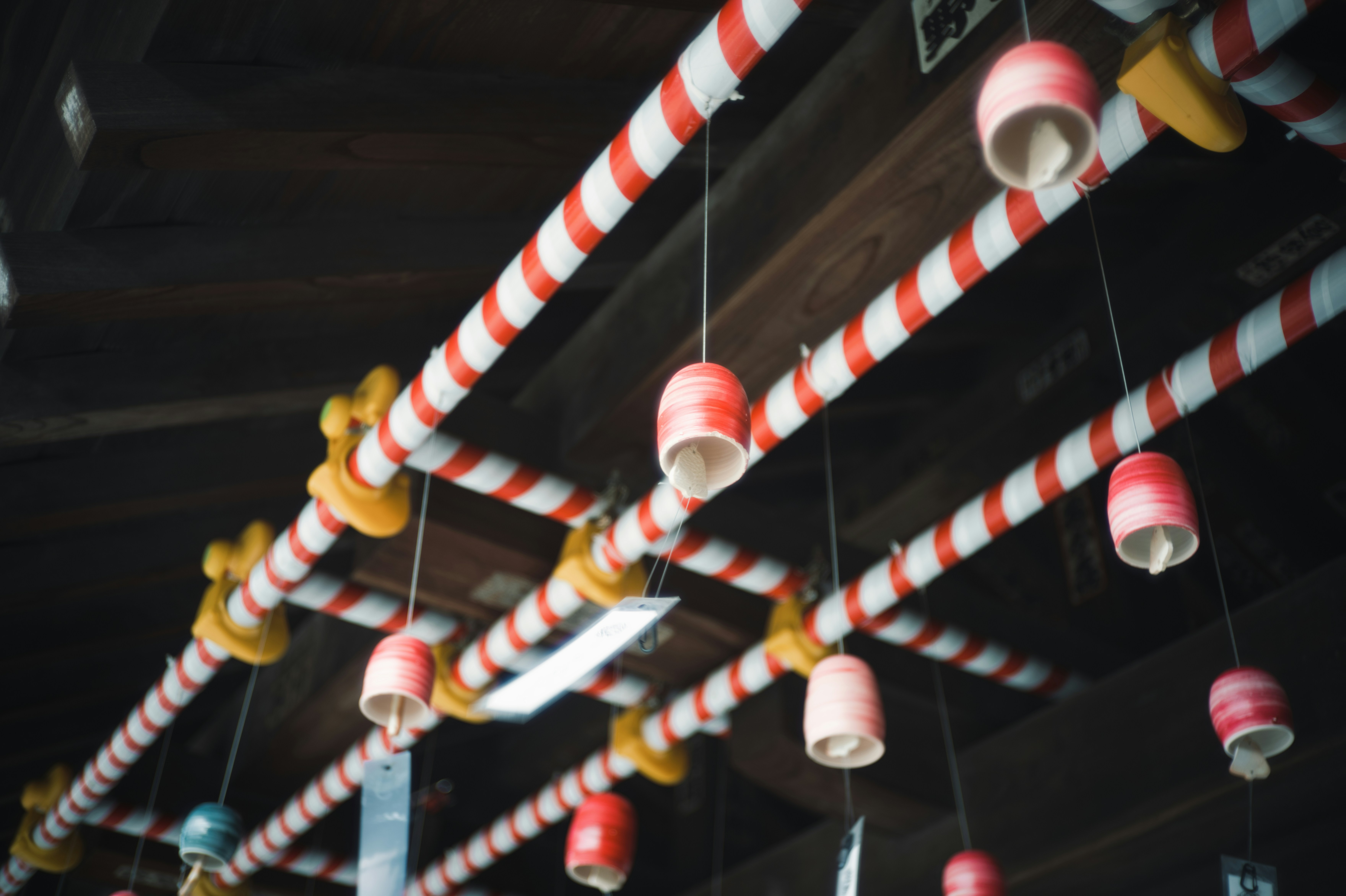 A row of candy canes hanging from a ceiling