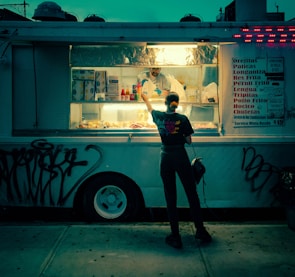 A man standing in front of a food truck