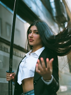 A woman with long hair holding a sword
