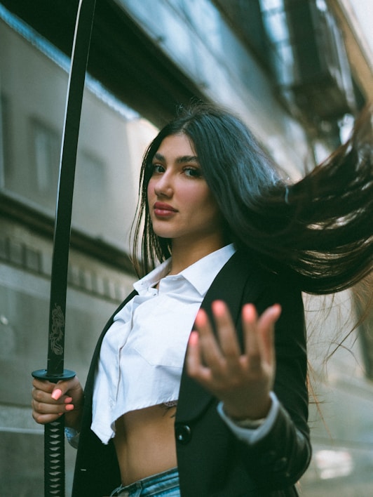 A woman with long hair holding a sword