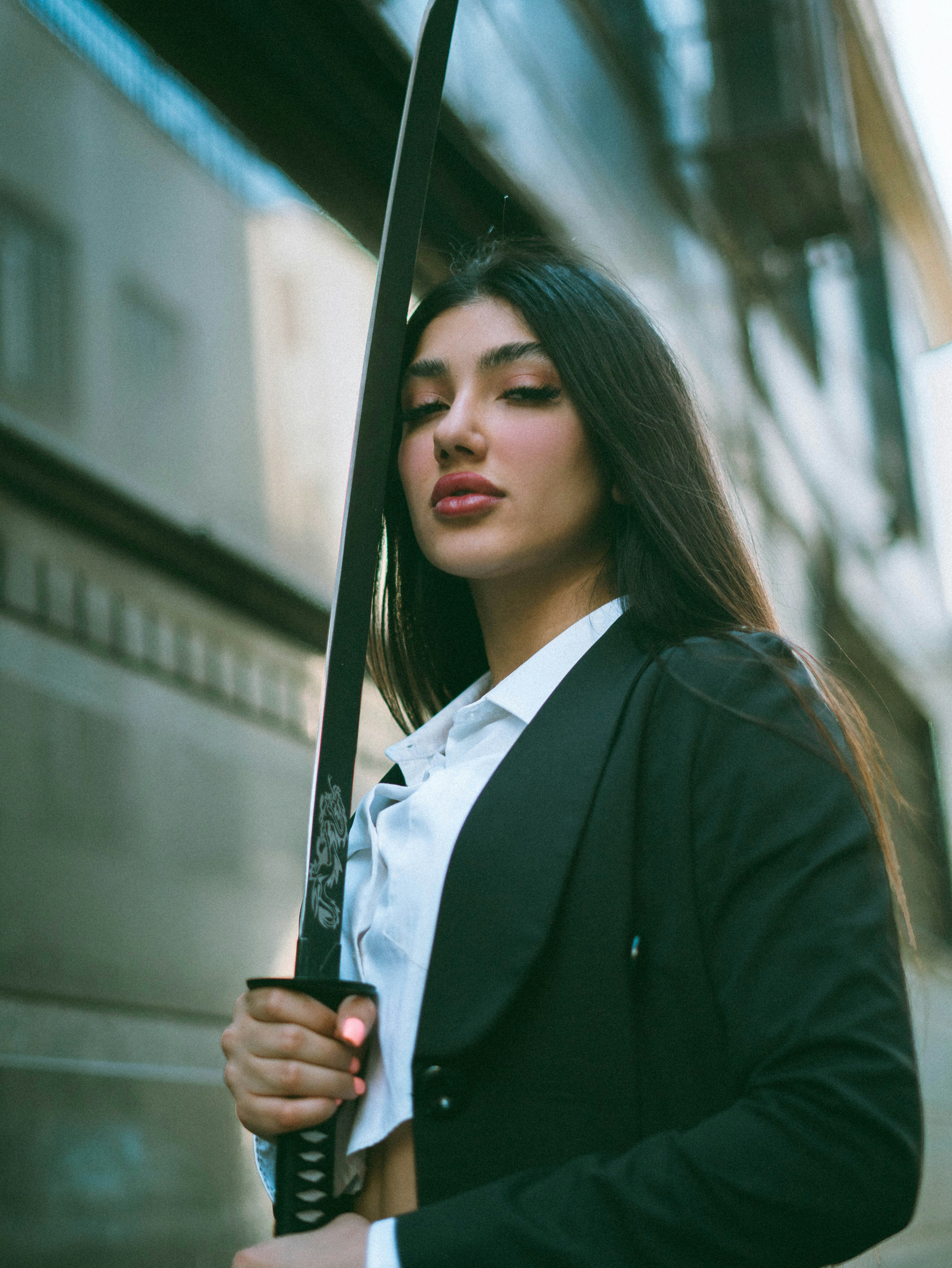 A woman holding a large sword in her hands