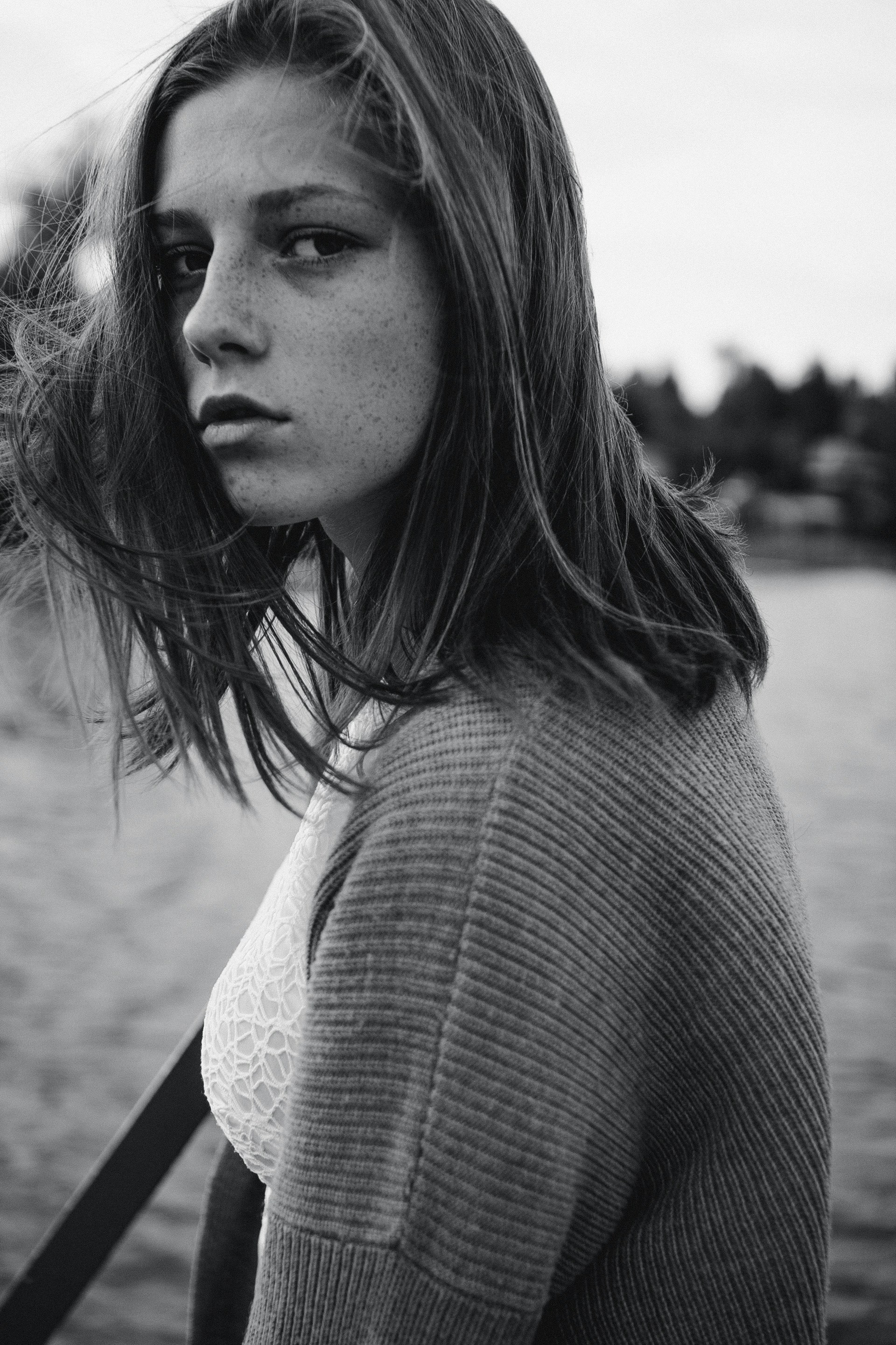 A woman standing next to a body of water