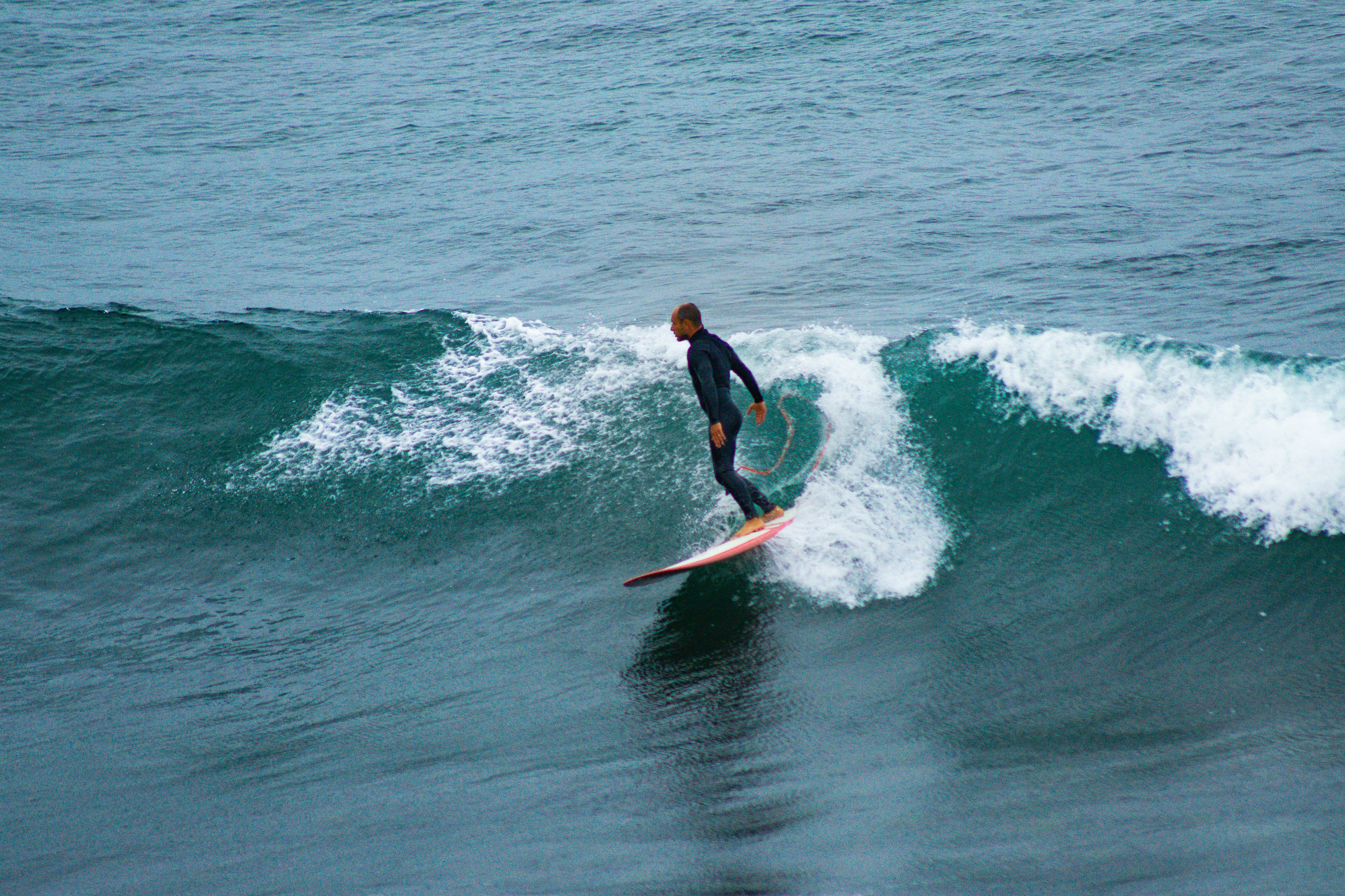 Surfers paddling out into the ocean.