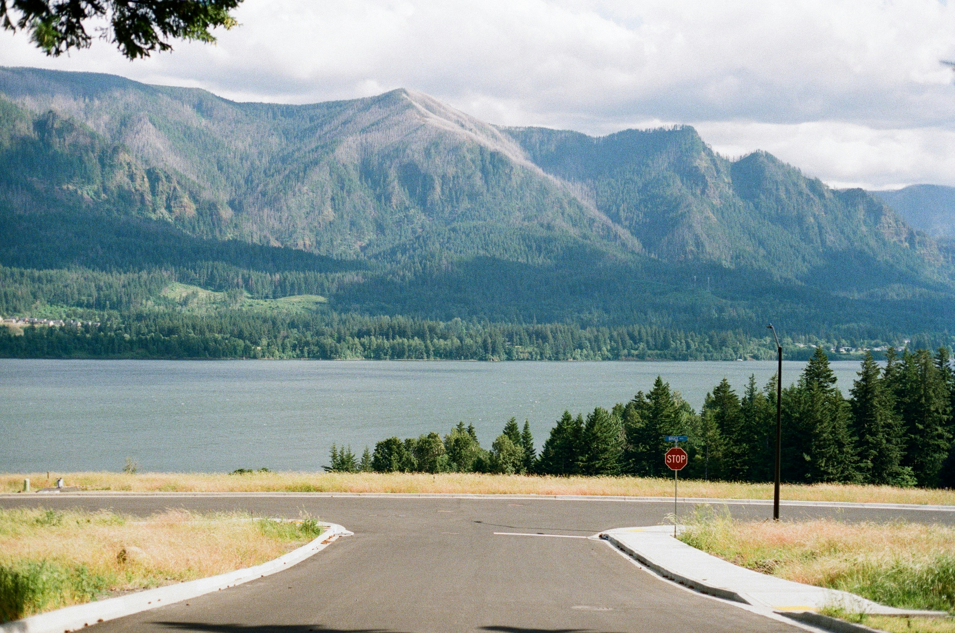 A view of a road with mountains in the background