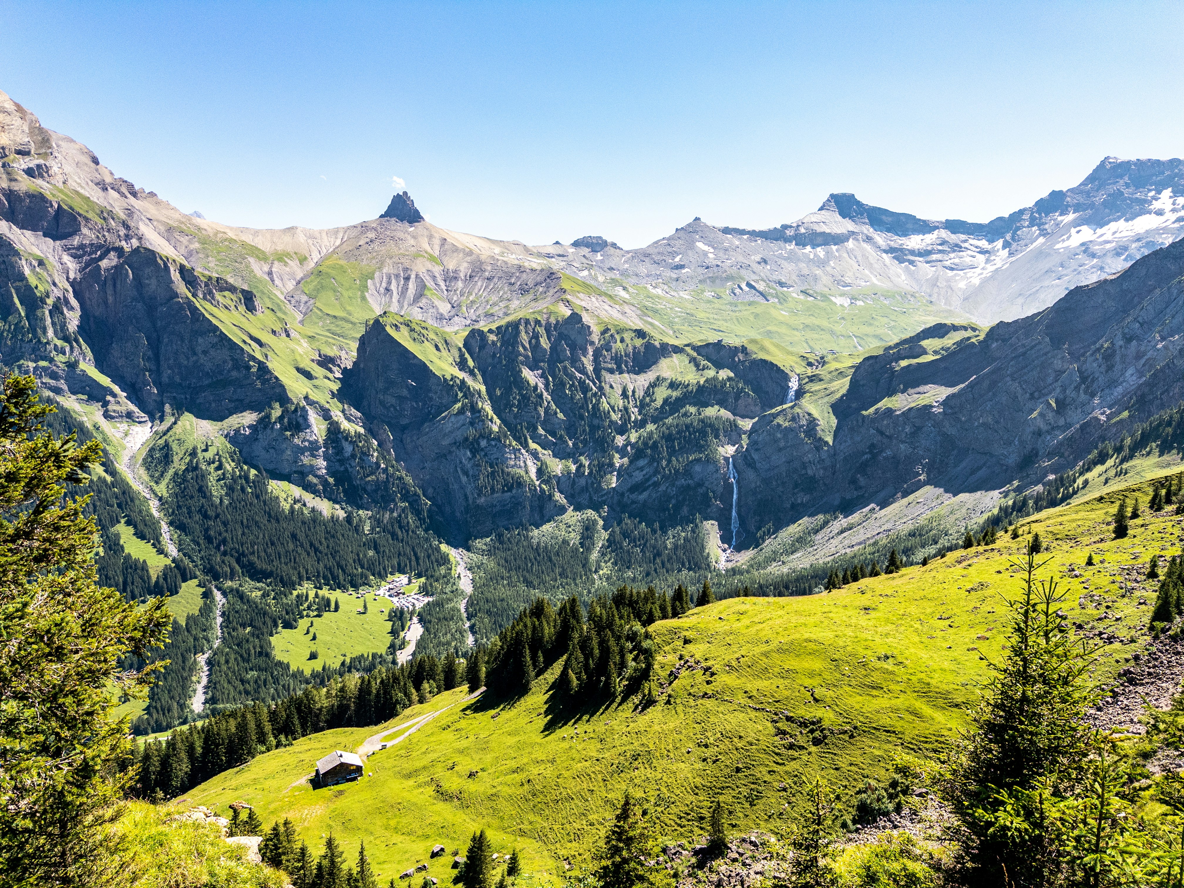 A scenic view of a mountain range with a valley in the foreground
