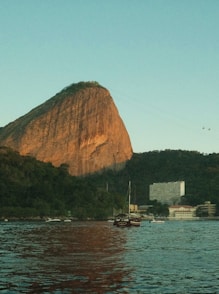 A large rock in the middle of a body of water