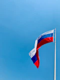 A red, white and blue flag flying in the wind