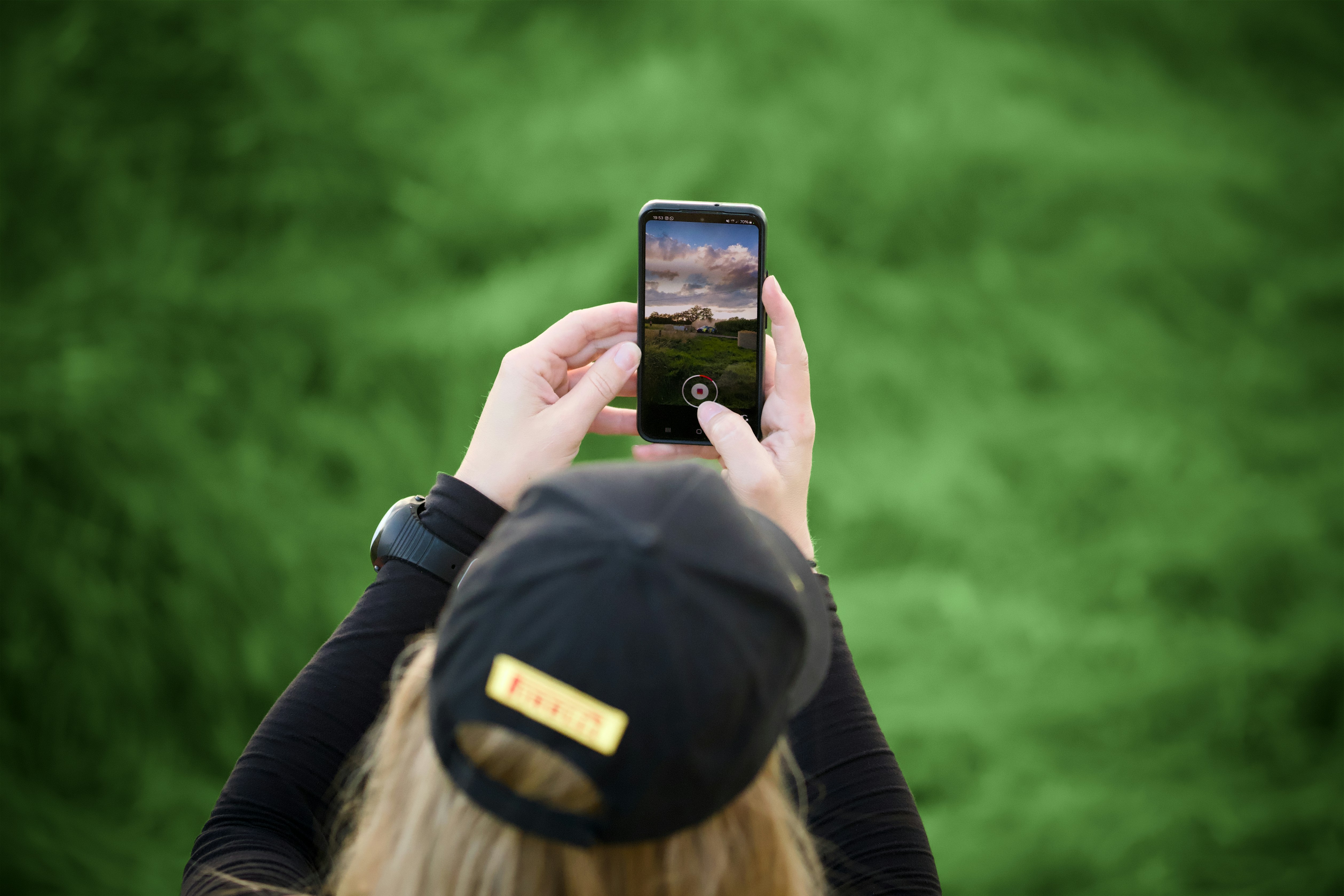A person taking a picture with a cell phone