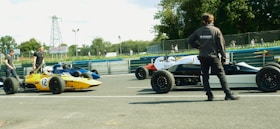 A man standing in front of a race car