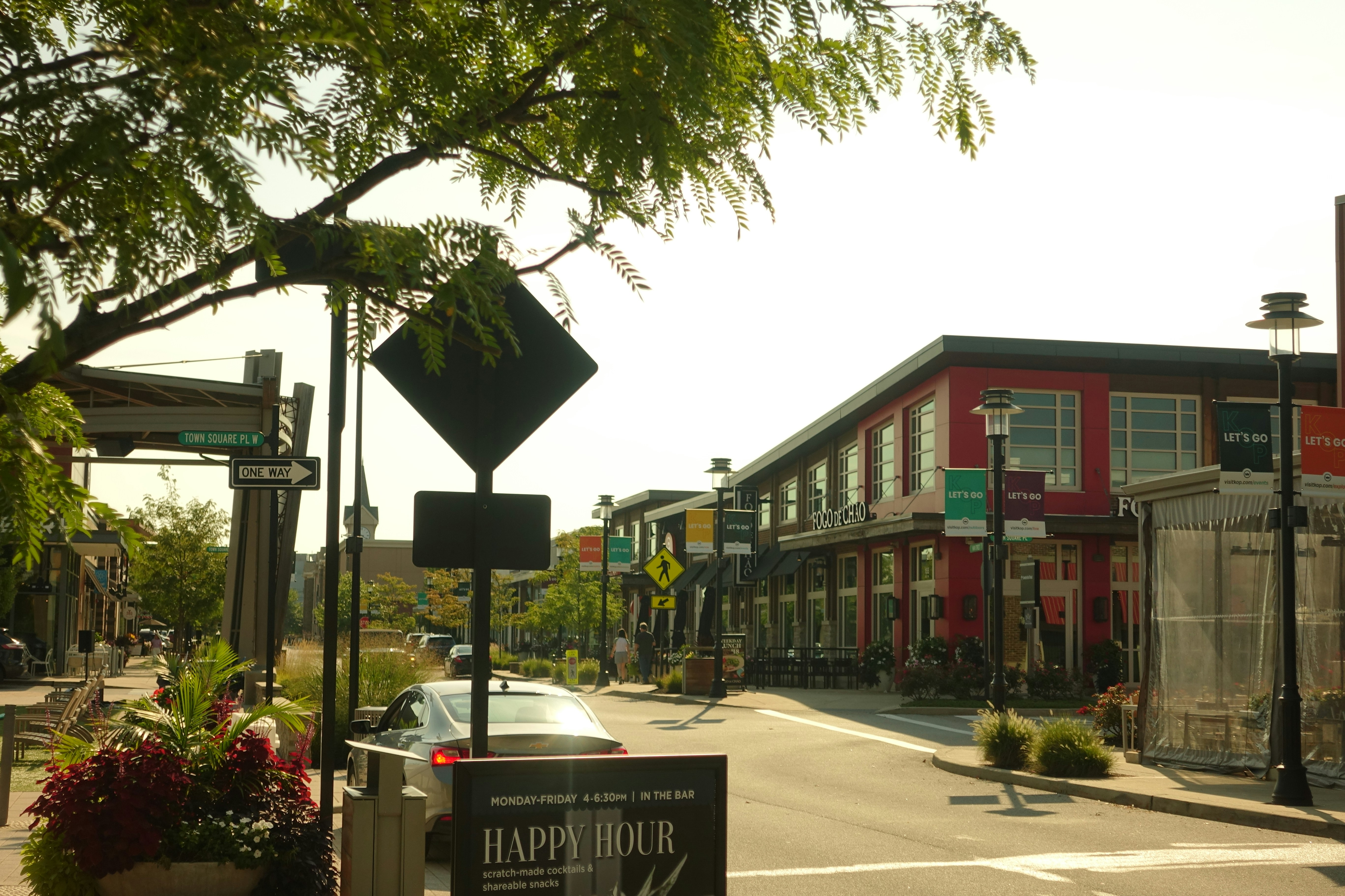 A view of a city street with a red building in the background