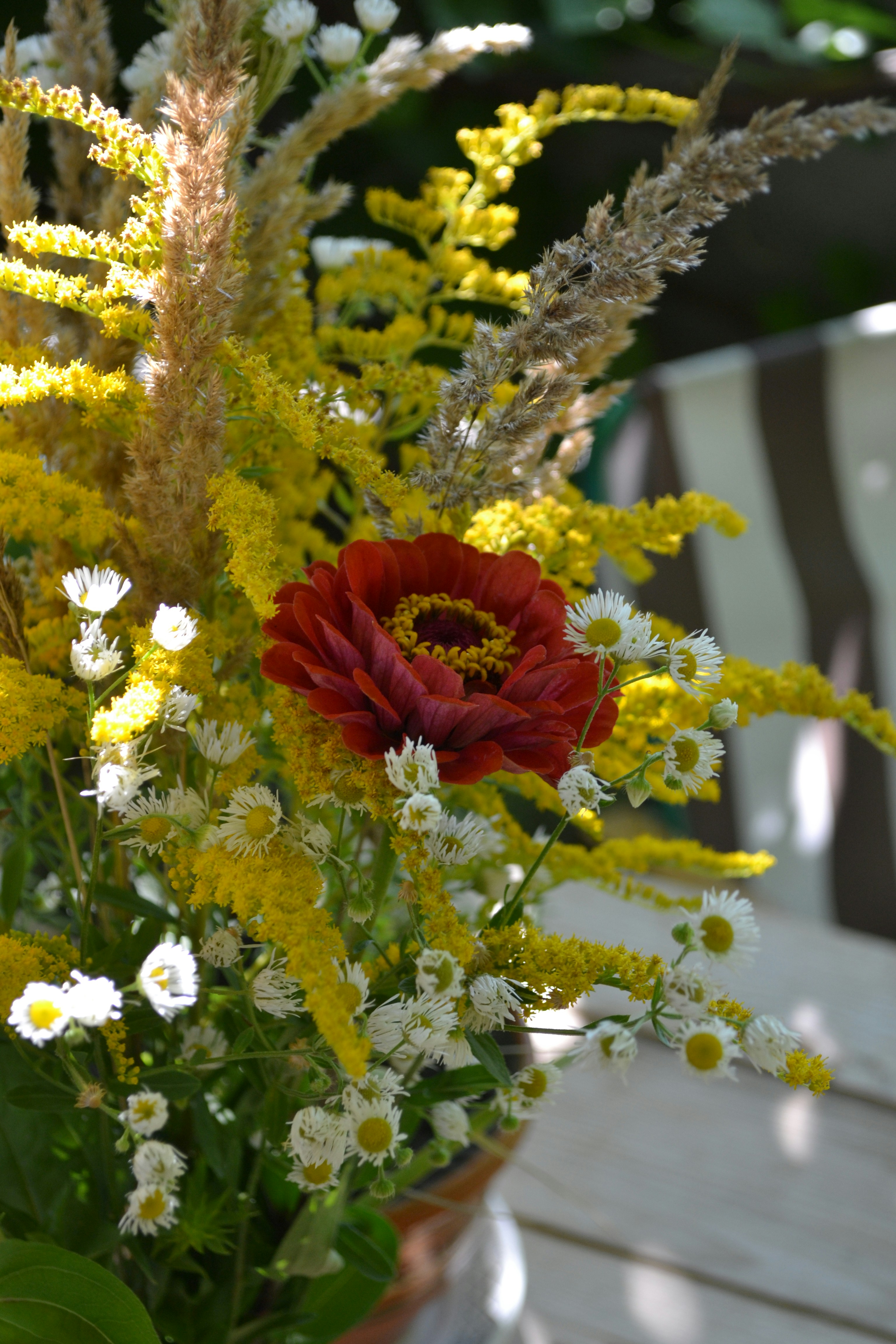 A vase filled with flowers sitting on top of a wooden table