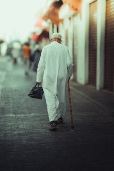 A man walking down the street with a cane