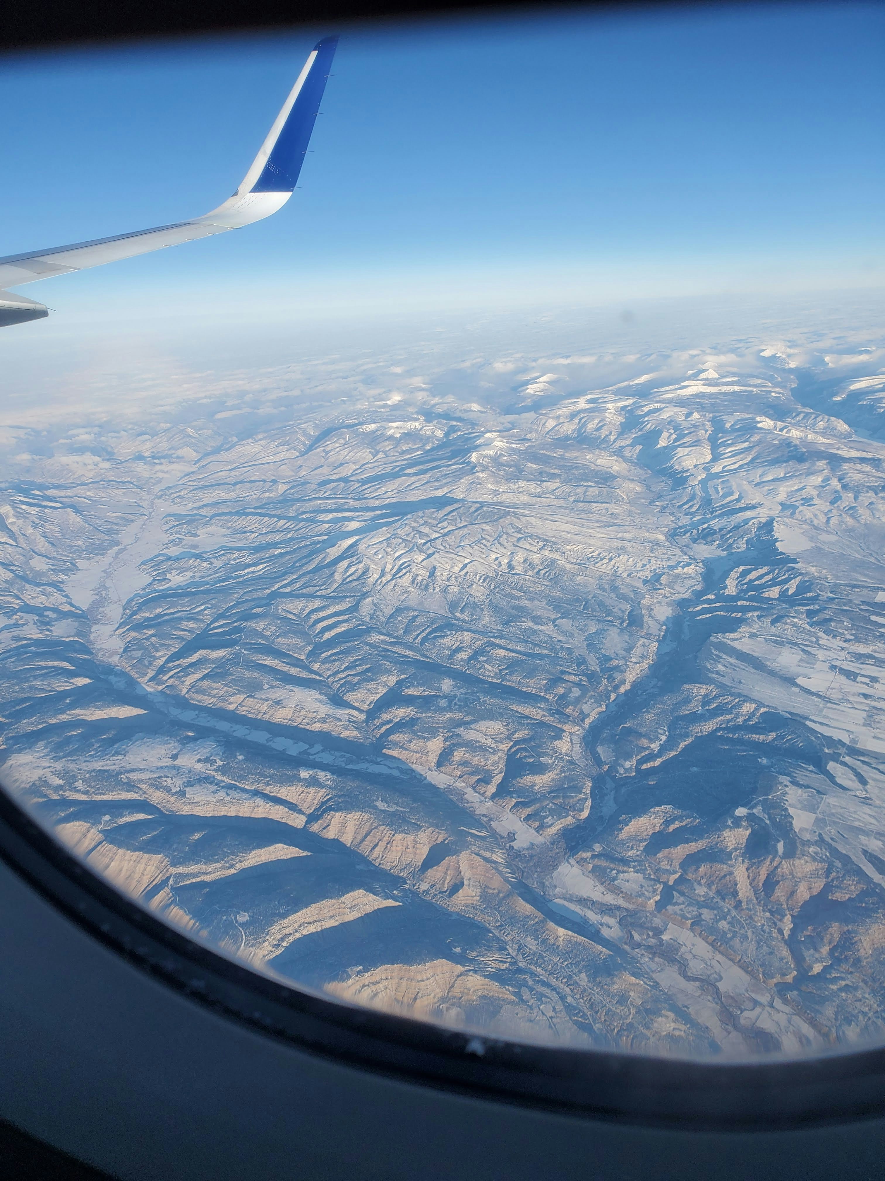 A view of a mountain range from an airplane window