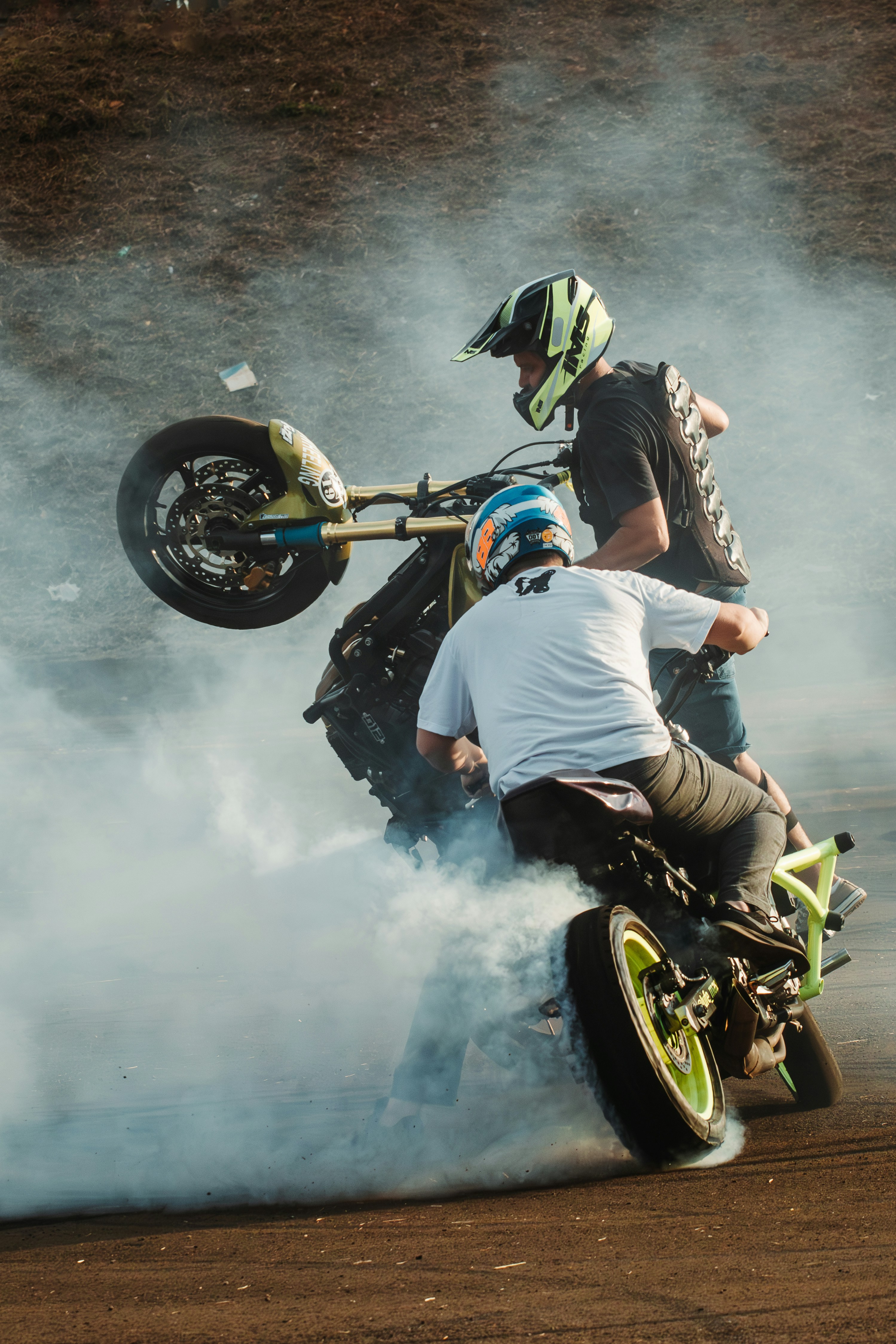 A man riding a motorcycle on top of a dirt bike