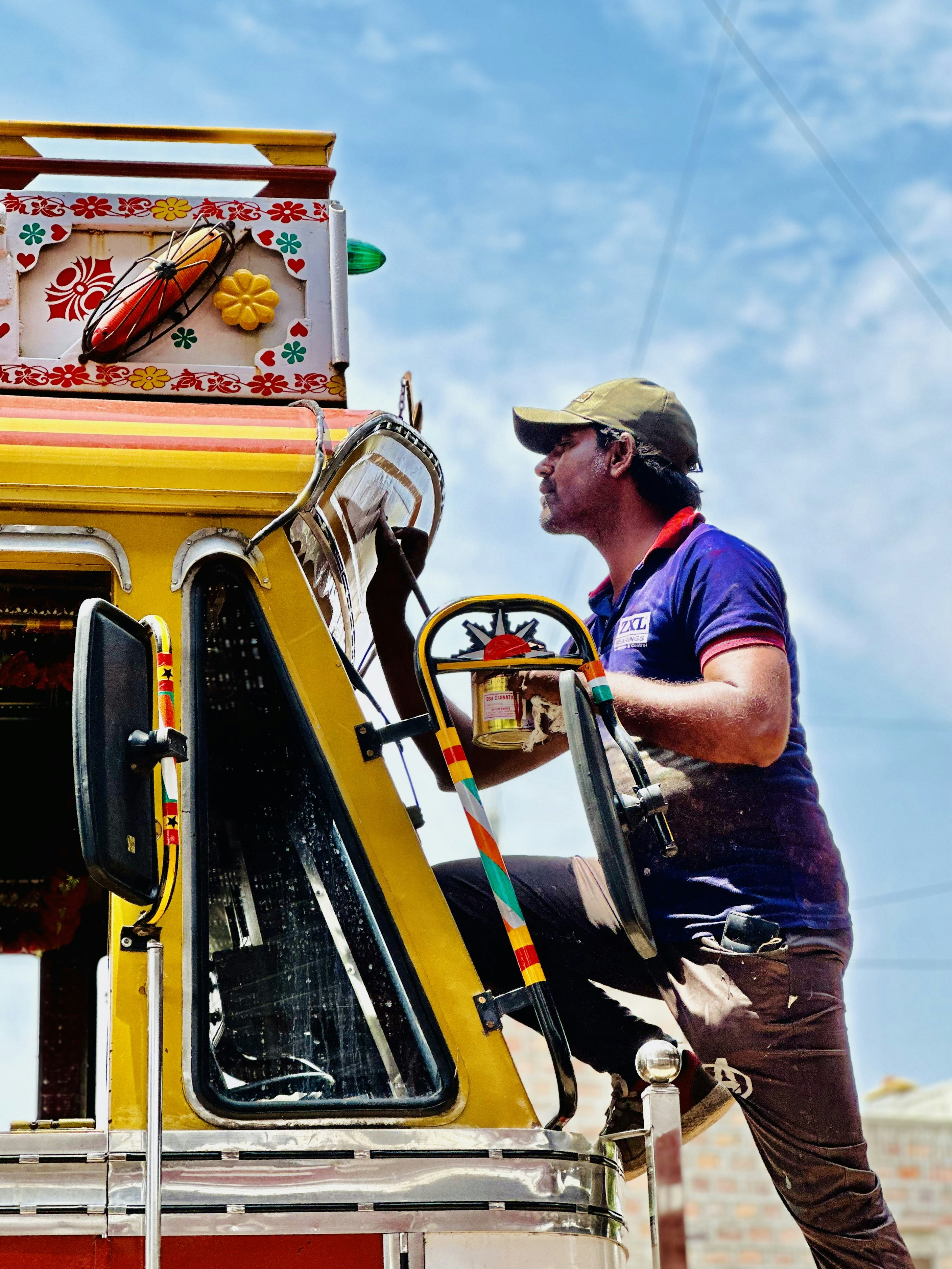 A man standing on top of a yellow truck