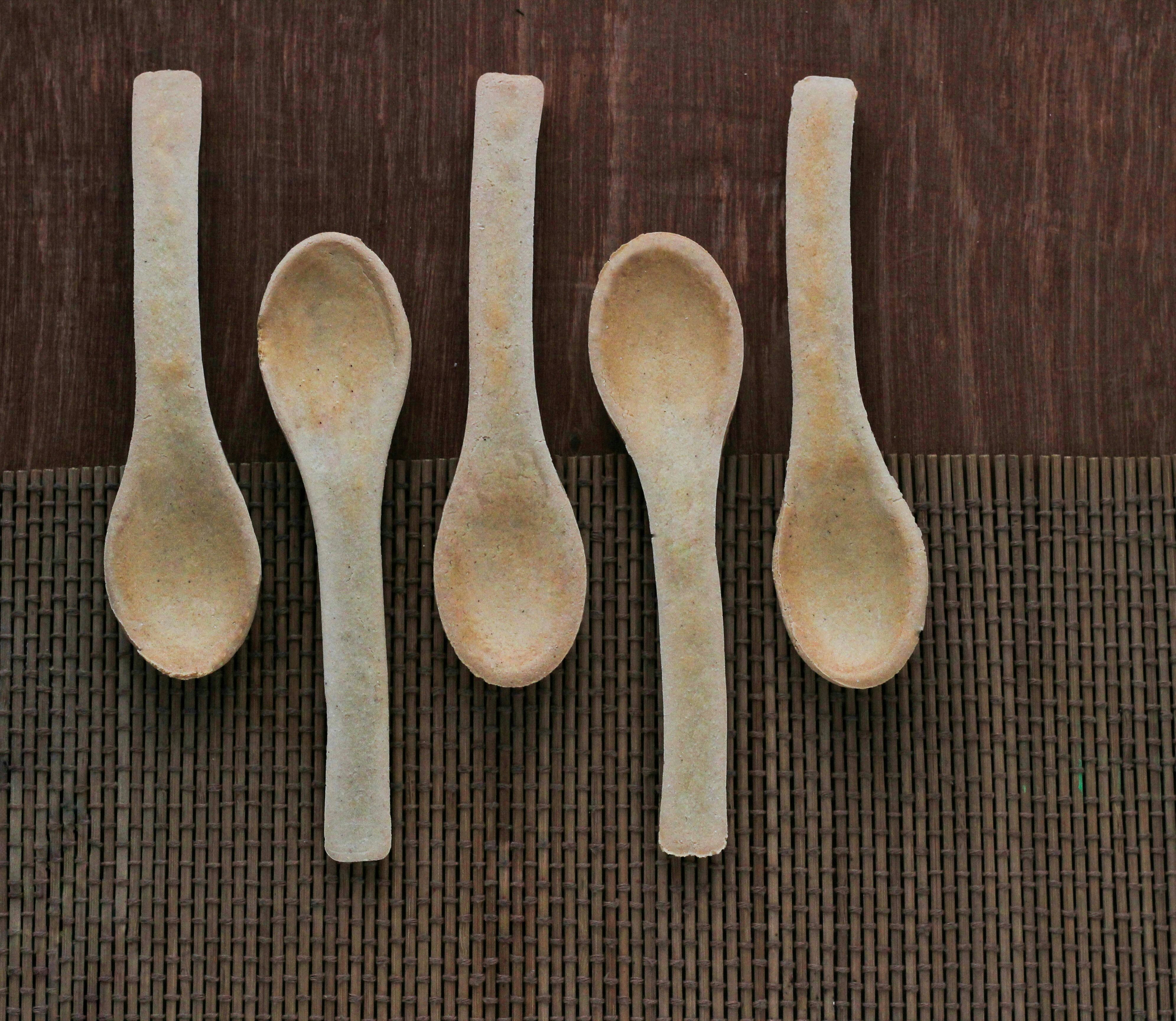 Five wooden spoons lined up in a row