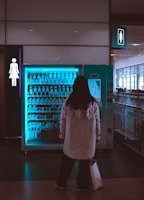 A woman standing in front of a vending machine