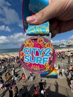 A person holding up a medal in front of a crowd of people