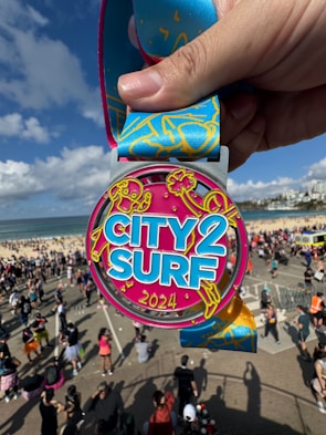 A person holding up a medal in front of a crowd of people