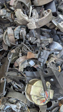 A pile of old metal parts sitting on top of each other