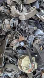 A pile of old metal parts sitting on top of each other