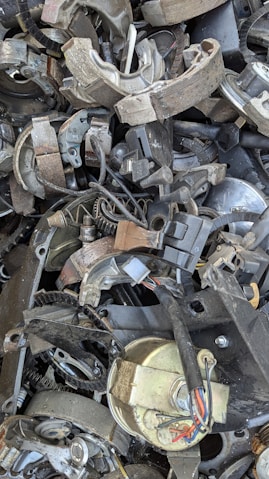 A pile of old metal parts sitting on top of each other