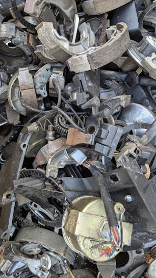 A pile of old metal parts sitting on top of each other