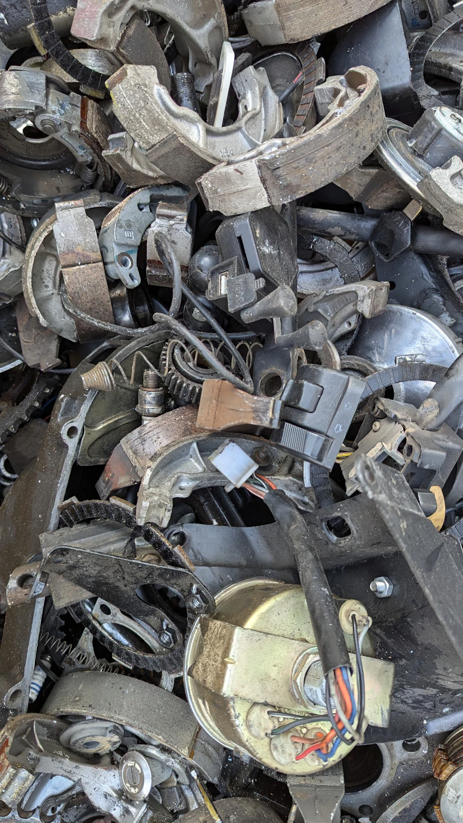 Pile of old metal parts stacked in a scrap yard