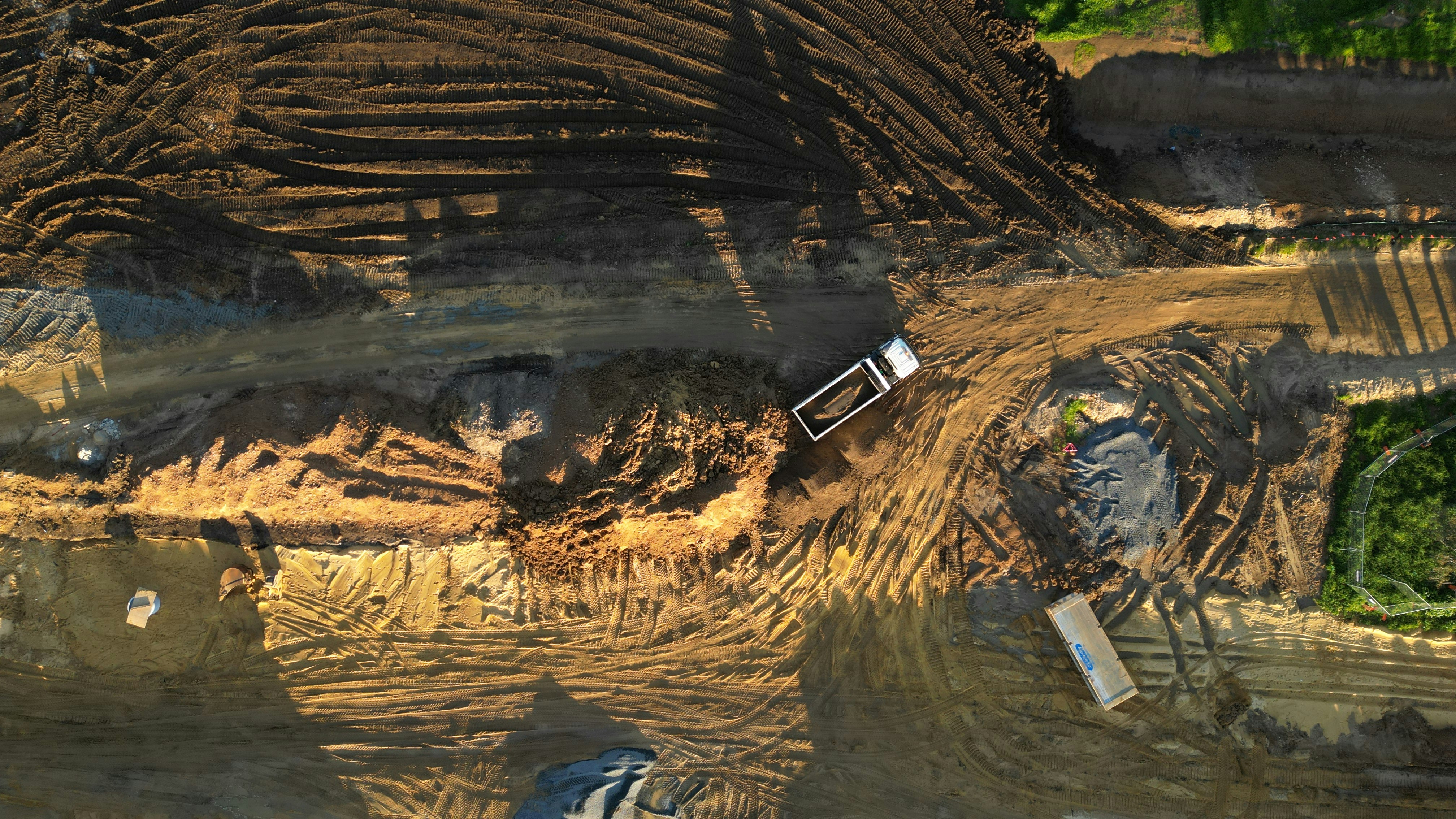 A dirt field with a construction truck