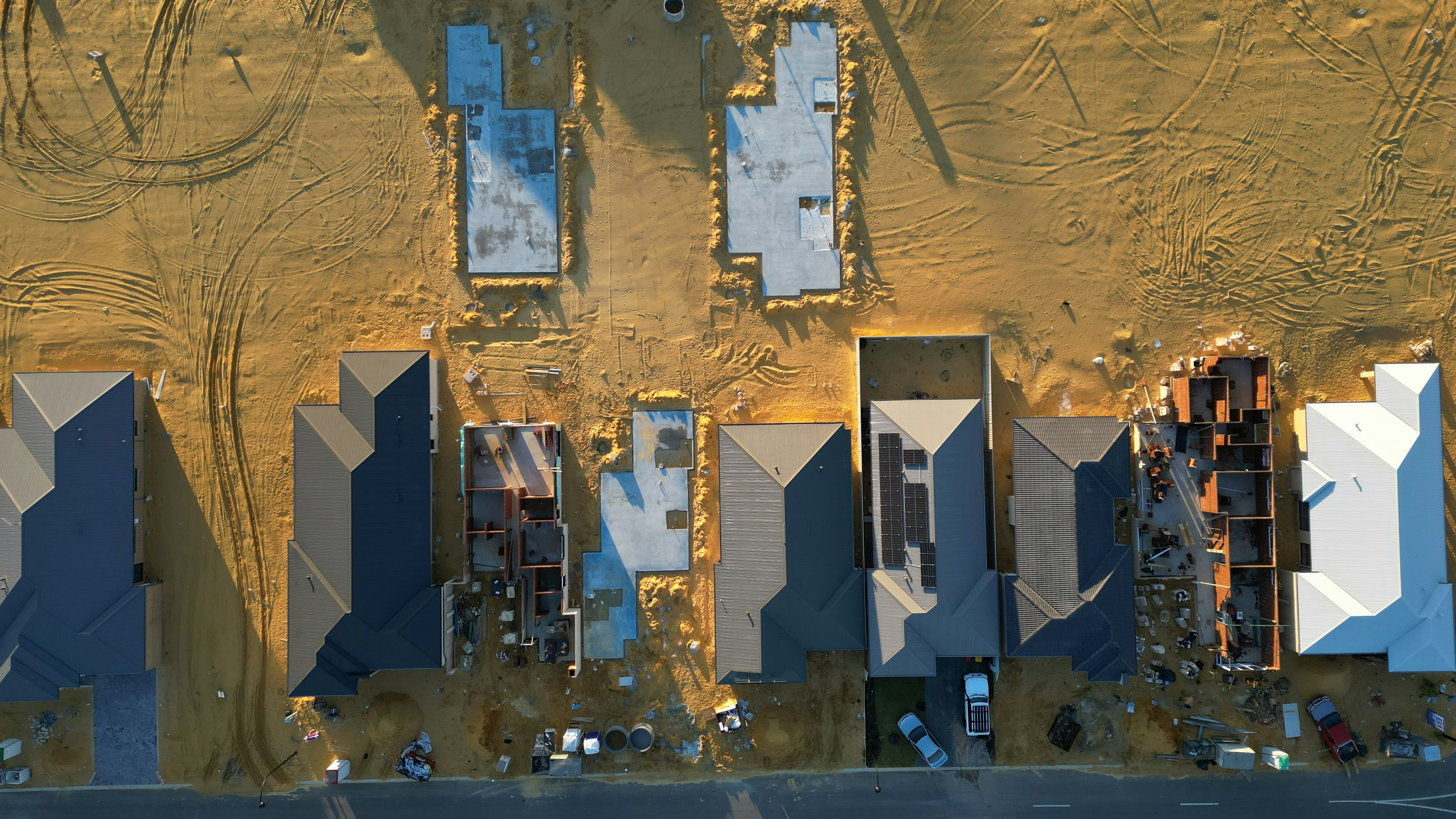 An aerial view of a construction site with blue shutters