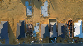 An aerial view of a construction site with blue shutters