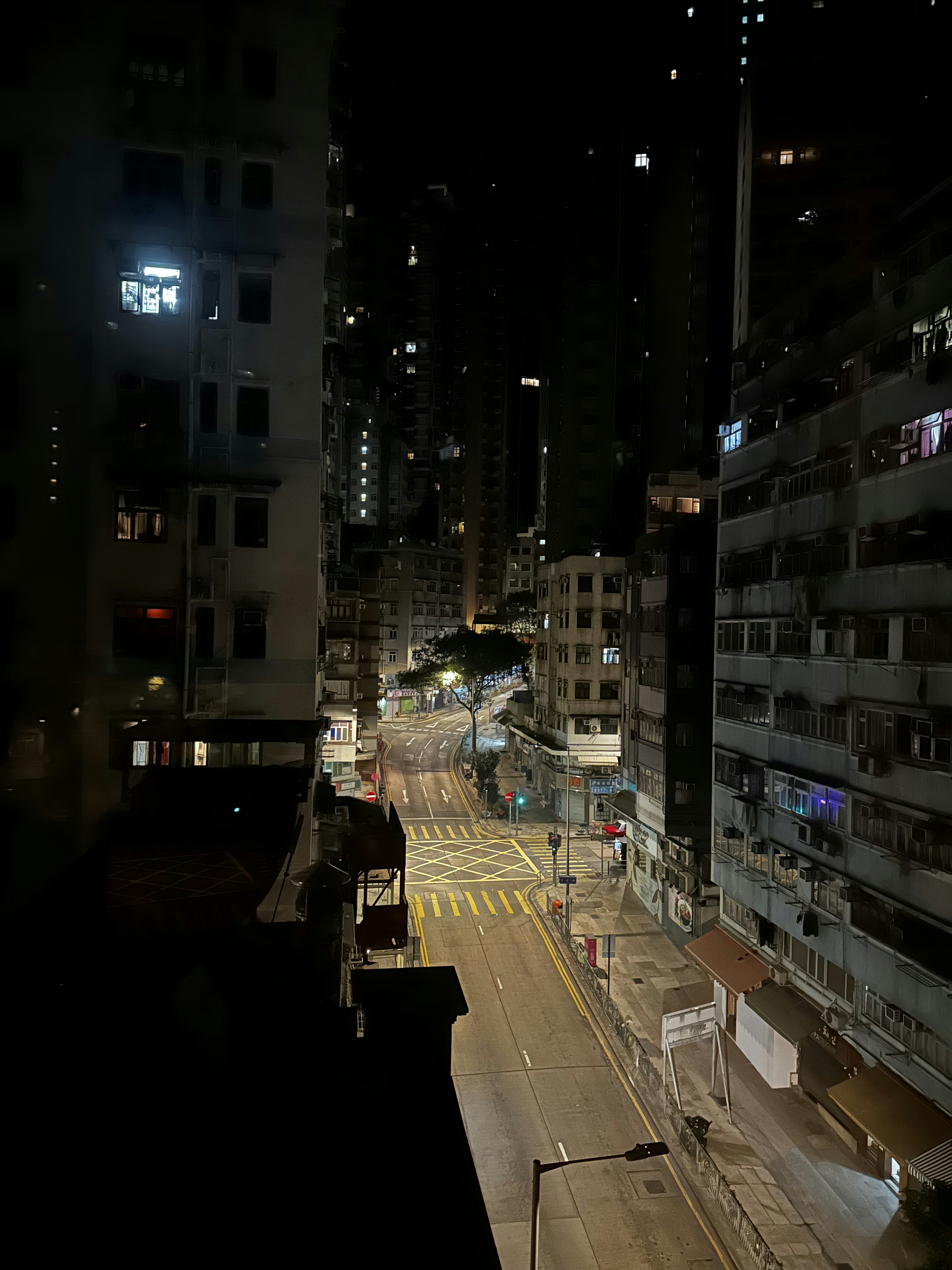 A city street at night with buildings lit up