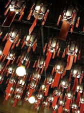 A room filled with lots of lights hanging from the ceiling