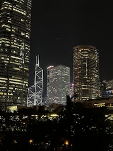 A city skyline at night with skyscrapers lit up