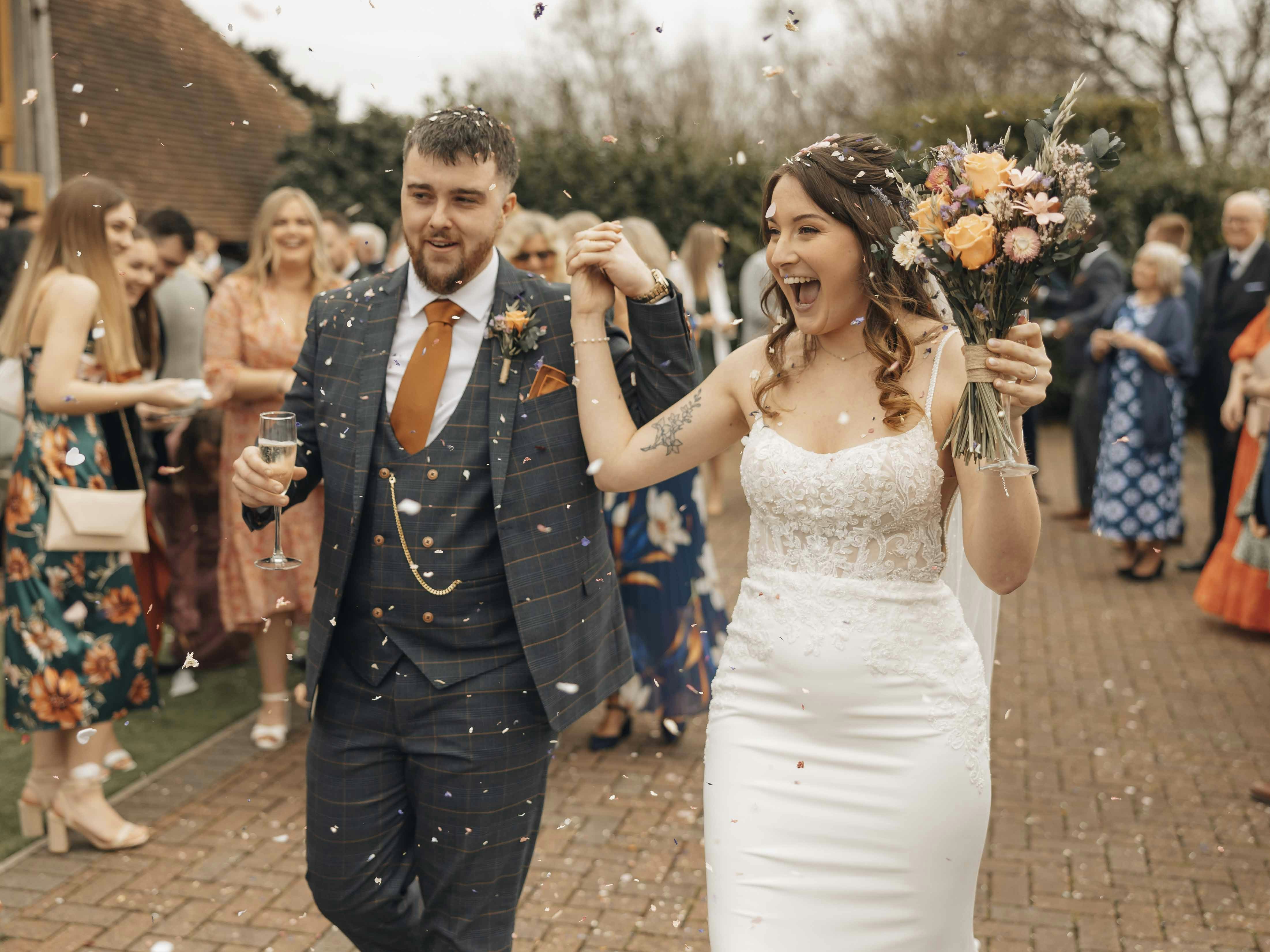 A newly married couple walking down the aisle