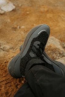 A person with their feet up on a rock