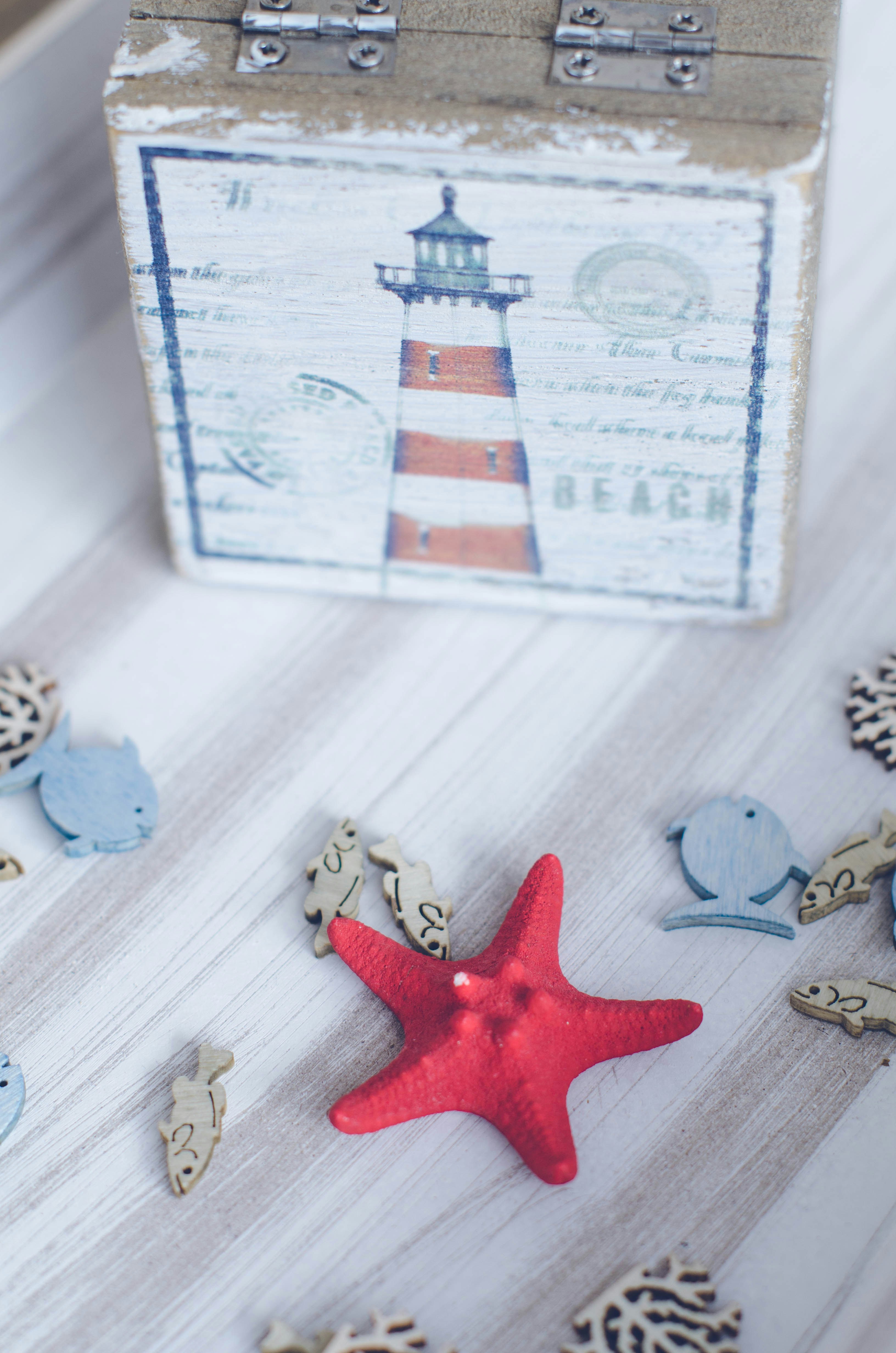 A red starfish sitting on top of a wooden box