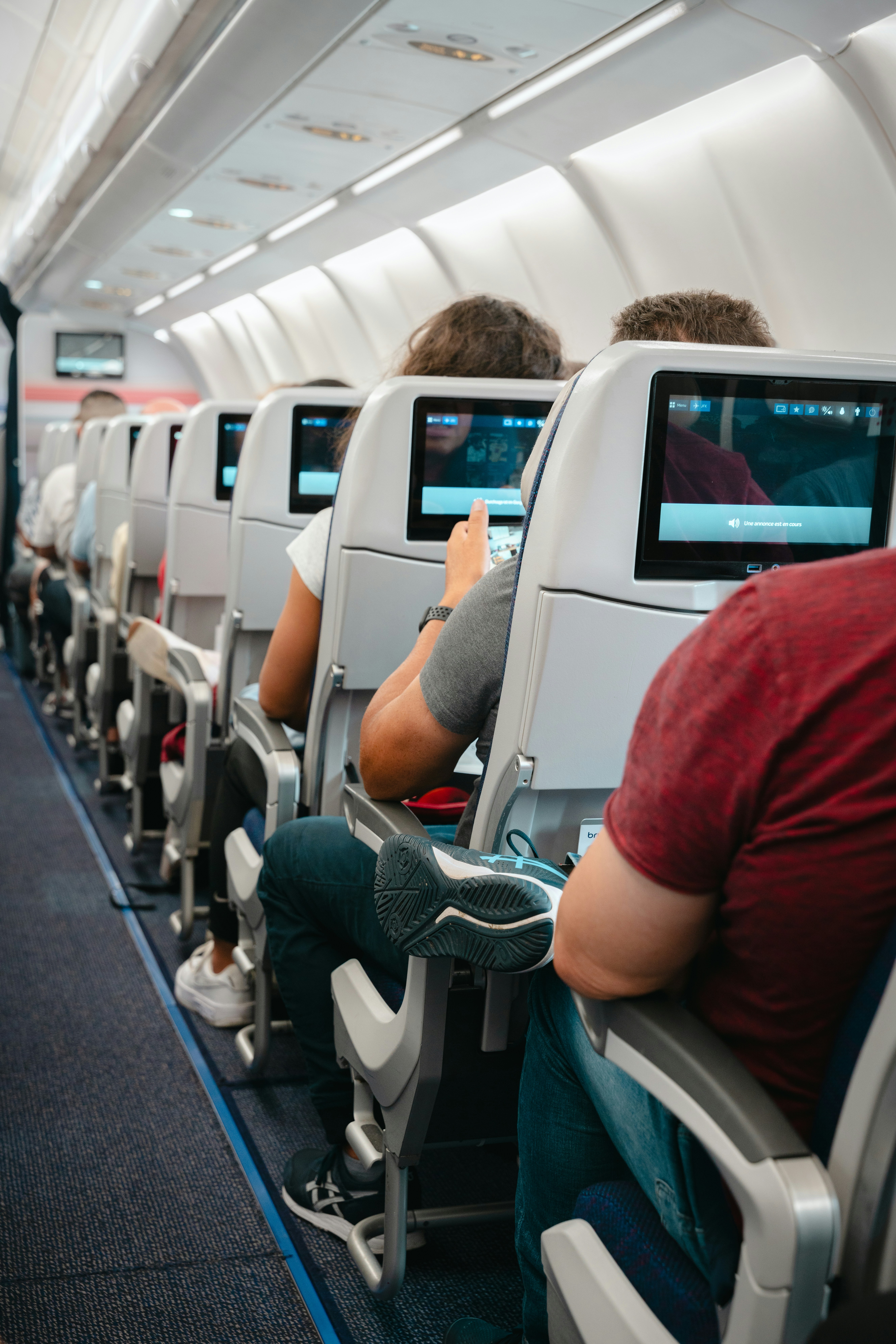 A group of people sitting on seats in an airplane