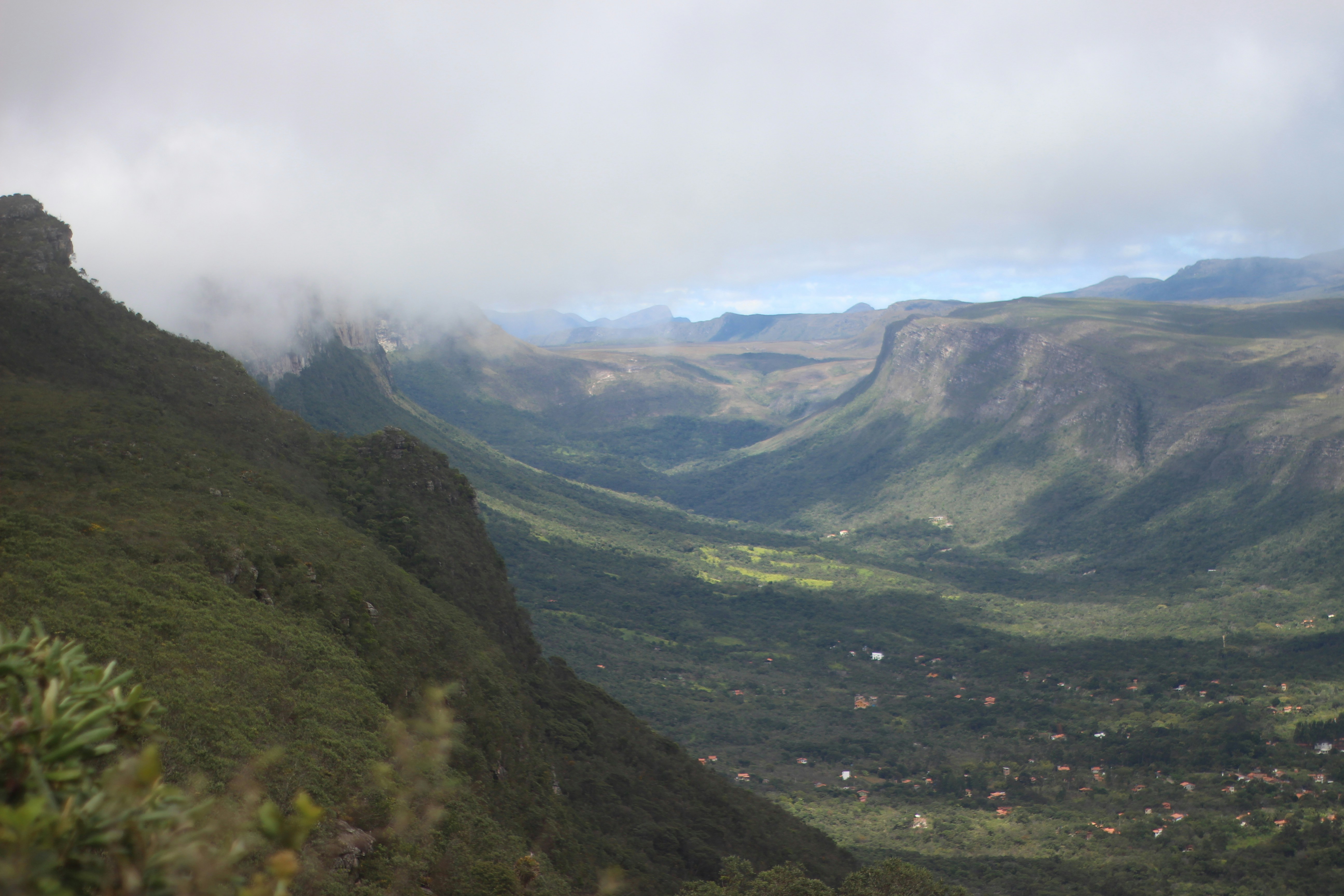 A view of a valley with mountains in the background