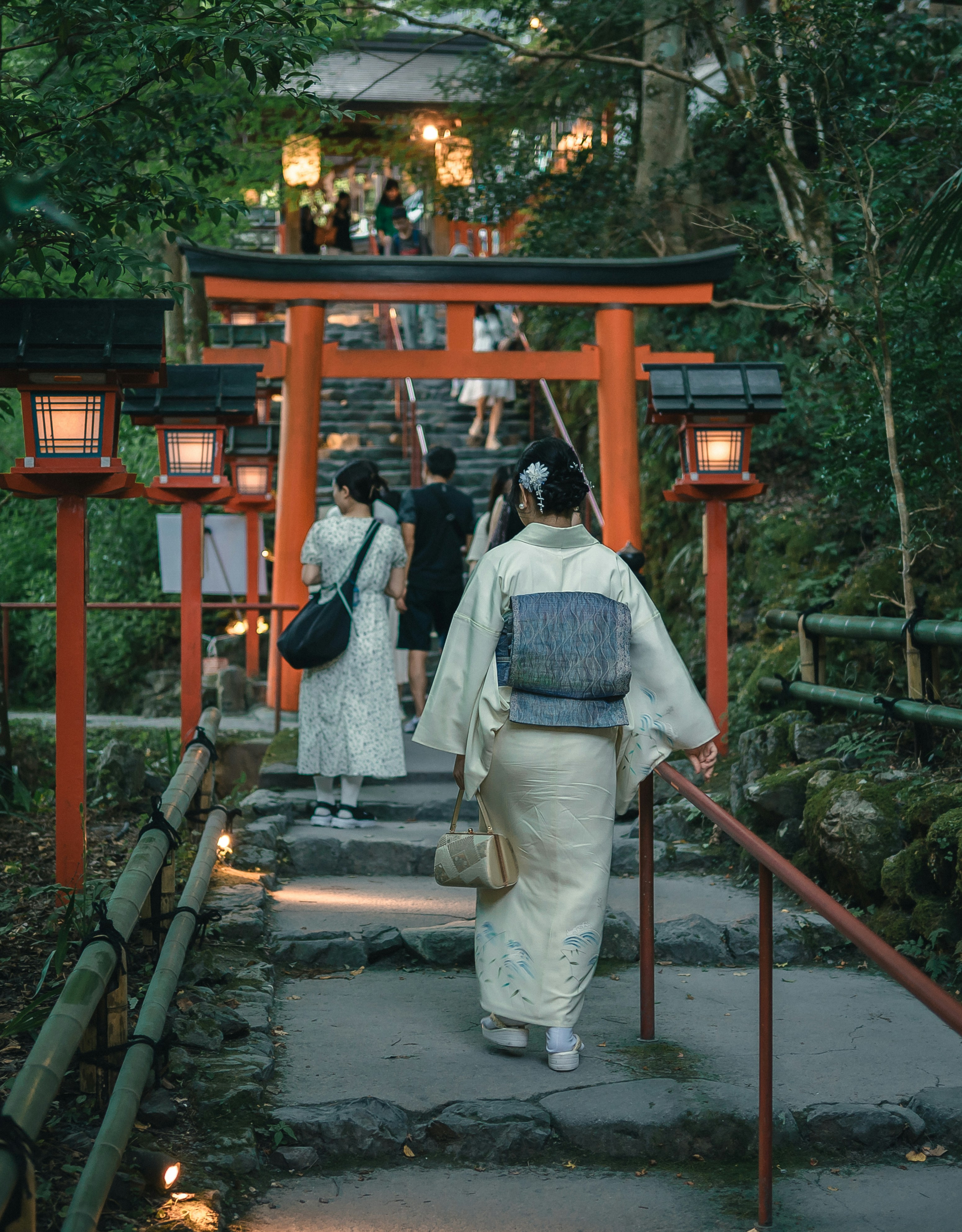 A group of people walking down a path in a forest