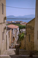 A narrow alley way with a view of a body of water