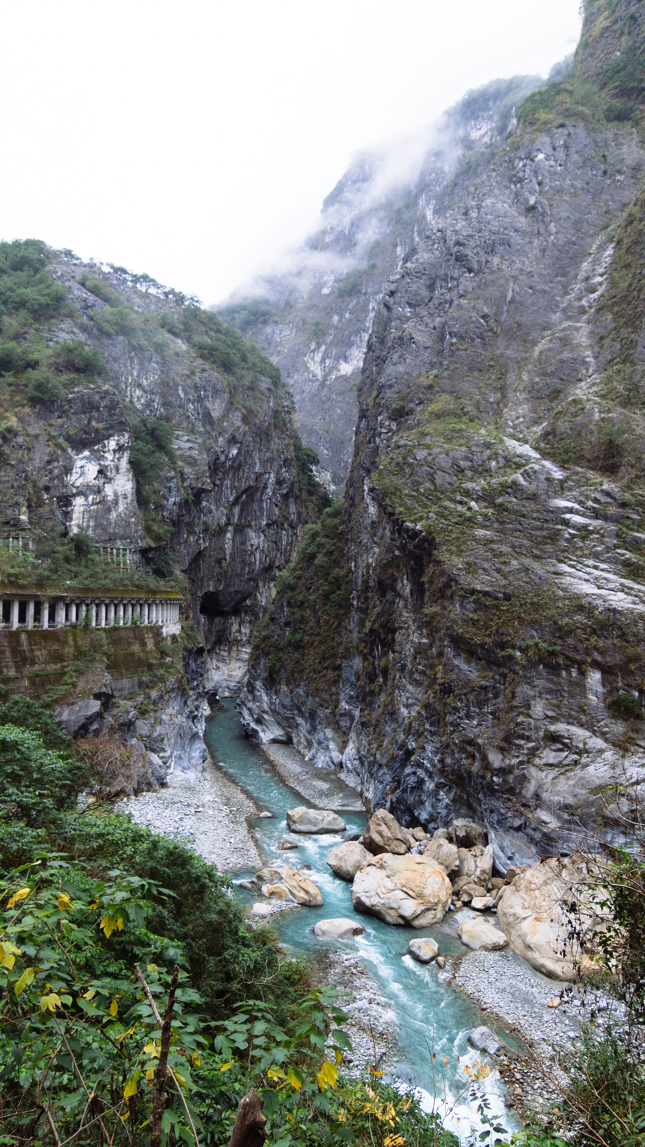 A river running through a lush green valley