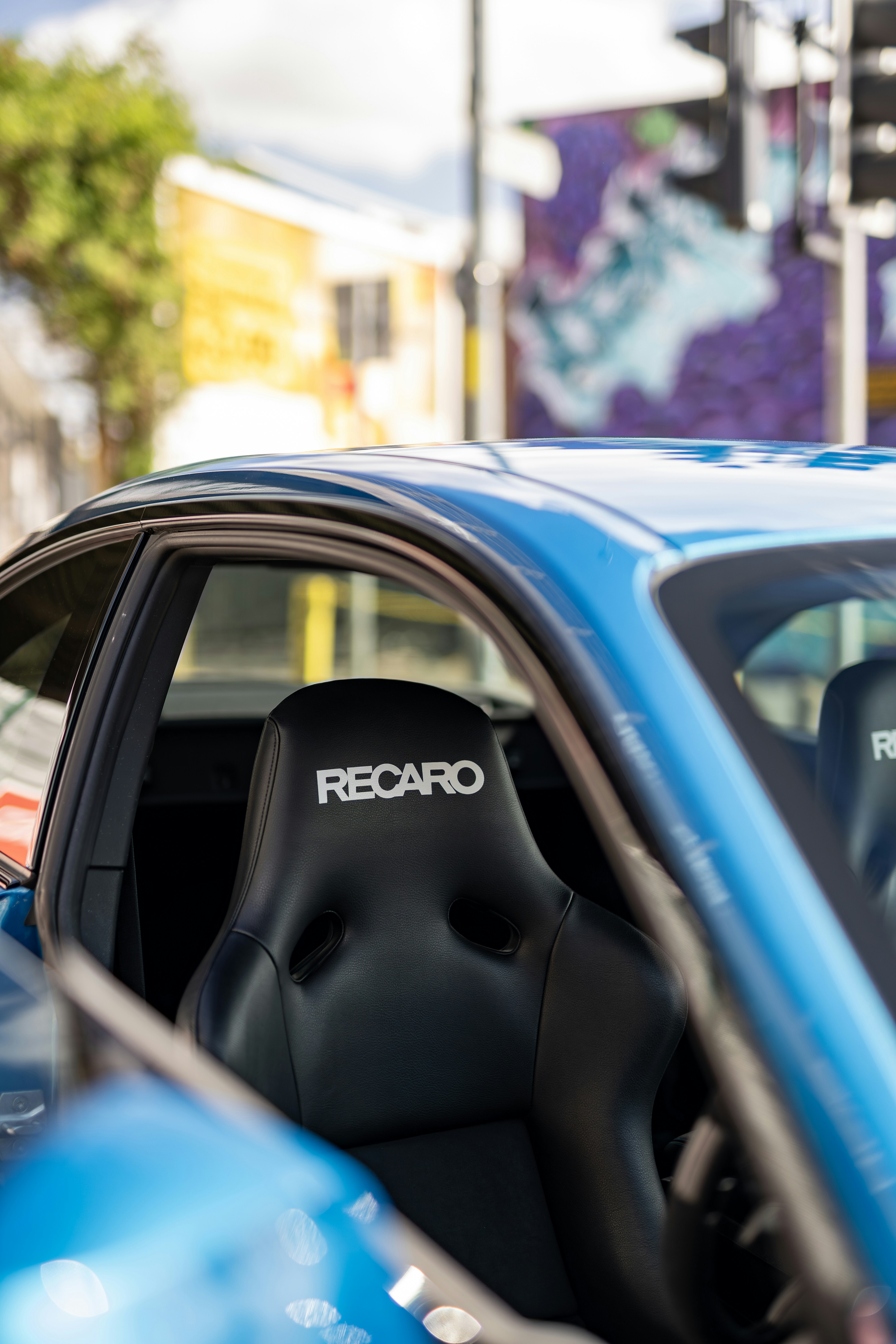 A blue car parked on the side of the road
