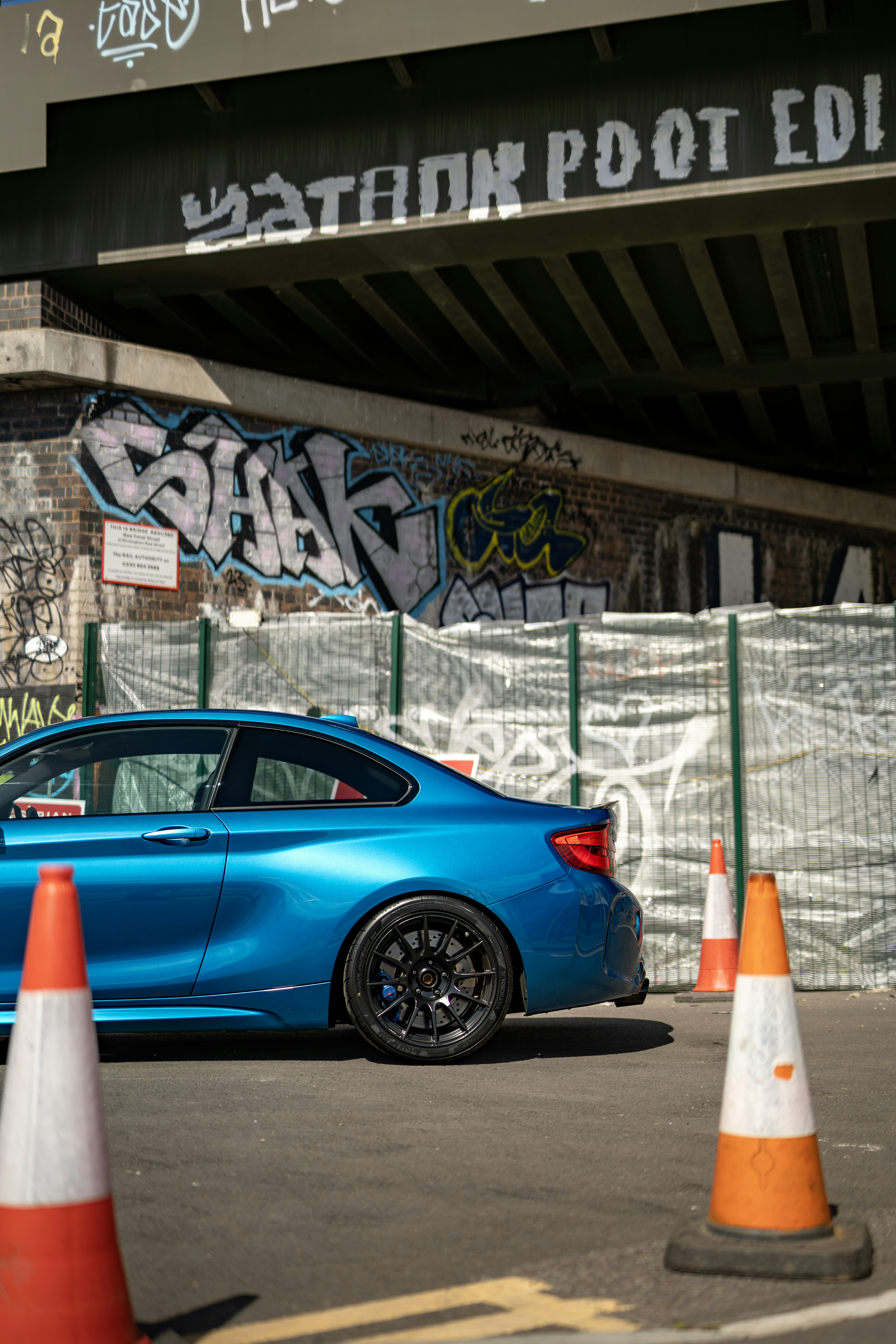 A blue car parked in front of a building