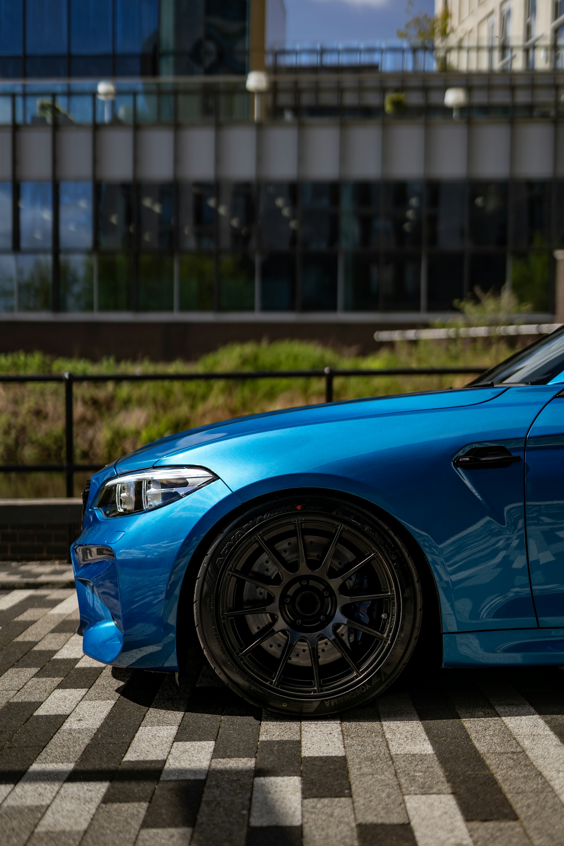 A blue car parked in front of a building