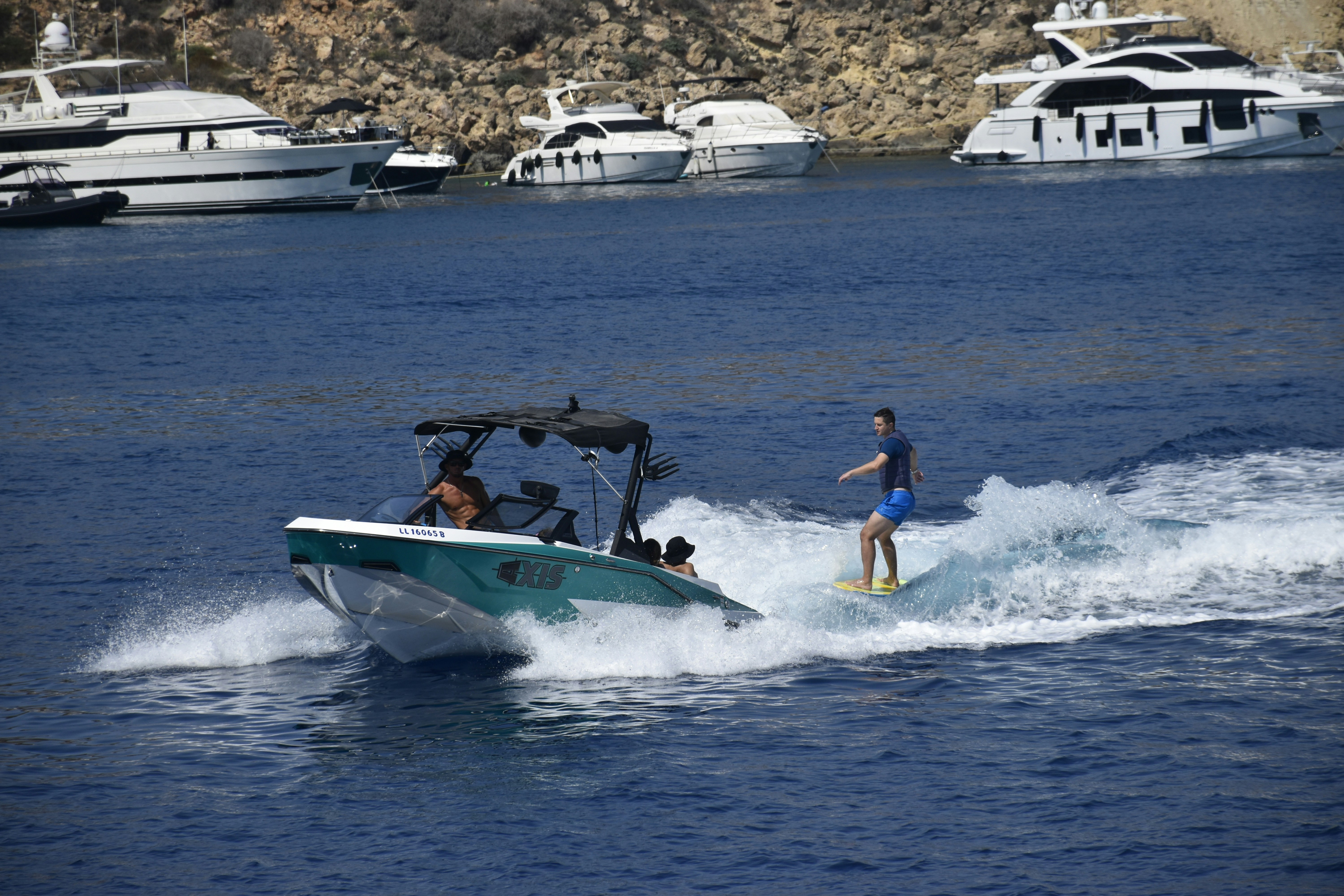 A man riding a boat on top of a body of water