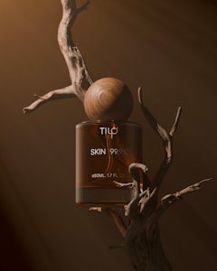 A bottle of tic skin 99 on a tree branch