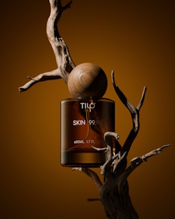 A bottle of tic skin oil sitting on top of a tree branch
